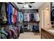 A walk-in closet with custom shelving and a small stool is next to the vanity at 4678 San Benito St, Las Vegas, NV 89121