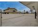 A gated concrete driveway with basketball hoop and backyard access at 4678 San Benito St, Las Vegas, NV 89121