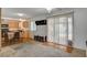 Open-concept living area with sliding doors to pool and view of kitchen and dining area at 4678 San Benito St, Las Vegas, NV 89121