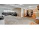 Spacious living room featuring a large sofa and view into the kitchen and dining area at 4678 San Benito St, Las Vegas, NV 89121
