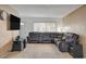 This cozy living room has plush seating, carpeted floors, and a modern entertainment center at 4678 San Benito St, Las Vegas, NV 89121