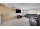 Comfortable living room featuring plush seating, carpeted floors, and bright natural light at 4678 San Benito St, Las Vegas, NV 89121