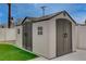 Backyard featuring dual storage sheds and artificial grass at 4678 San Benito St, Las Vegas, NV 89121