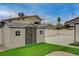 Backyard storage shed with double doors and windows and a large driveway space at 4678 San Benito St, Las Vegas, NV 89121