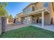 Spacious backyard with a well-maintained artificial grass, a patio, and a hot tub for outdoor enjoyment at 5024 Stone Bay Ave, Las Vegas, NV 89131