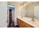 Bathroom with wood cabinets, double sink vanity, and shower with tub at 5024 Stone Bay Ave, Las Vegas, NV 89131