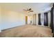 Large carpeted bedroom with natural lighting, ceiling fan, and closet at 5024 Stone Bay Ave, Las Vegas, NV 89131
