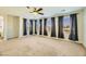 Carpeted bedroom featuring a ceiling fan, recessed lights, and big windows at 5024 Stone Bay Ave, Las Vegas, NV 89131