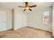 This bedroom features carpet flooring, a ceiling fan, and a sliding closet at 5024 Stone Bay Ave, Las Vegas, NV 89131