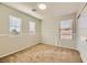 Bright bedroom with neutral walls, carpet flooring, and two windows for natural light at 5024 Stone Bay Ave, Las Vegas, NV 89131