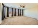 Spacious carpeted bedroom with a ceiling fan, recessed lights, and large windows at 5024 Stone Bay Ave, Las Vegas, NV 89131