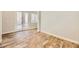 Open room with wood tile floor, white trim, and double doors at 5024 Stone Bay Ave, Las Vegas, NV 89131