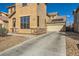 Two-story home features a two-car garage and a desert-landscaped front yard at 5024 Stone Bay Ave, Las Vegas, NV 89131