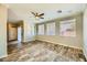Living room with wood-look floors and many windows providing natural light at 5024 Stone Bay Ave, Las Vegas, NV 89131