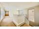 Bright open loft area with carpet flooring, stairway with white railing and plenty of natural light at 5024 Stone Bay Ave, Las Vegas, NV 89131