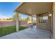 A covered patio and private backyard featuring a small grass area and a hardscaped area with a hot tub at 5024 Stone Bay Ave, Las Vegas, NV 89131