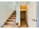 Carpeted stairway featuring a side closet and natural light, providing both functionality and style at 5024 Stone Bay Ave, Las Vegas, NV 89131