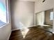 Bedroom showcasing modern closet, wood floors, and natural light from a window at 5263 Shasta Lake Way, Las Vegas, NV 89118