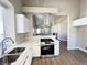 Updated kitchen featuring white cabinets, stainless steel appliances, and open to the living area at 5263 Shasta Lake Way, Las Vegas, NV 89118