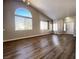 Open living space featuring wood floors, large windows, and vaulted ceilings at 5263 Shasta Lake Way, Las Vegas, NV 89118