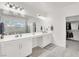 Bright bathroom featuring a large mirror, white cabinets, and a view of the glass walk-in shower and walk-in closet at 5555 E San Pietro Dr, Pahrump, NV 89061