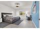 Bright bedroom features stylish light fixture, accent chair, and a comfortable queen-size bed with soft, neutral bedding at 5555 E San Pietro Dr, Pahrump, NV 89061
