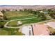Scenic aerial view of the golf course with lush green fairways and mature trees at 5555 E San Pietro Dr, Pahrump, NV 89061