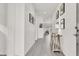 Bright hallway with light-grey wood-look flooring, white walls and stylish decor at 5555 E San Pietro Dr, Pahrump, NV 89061