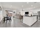 Open-concept living area with a modern kitchen, dining space, and a comfortable seating area at 5555 E San Pietro Dr, Pahrump, NV 89061