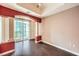 Bright room with hardwood floors, access to balcony, and decorative pillars at 56 E Serene Ave # 306, Las Vegas, NV 89123