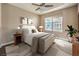 Comfortable bedroom with ceiling fan and neighborhood views from large bright windows at 56 E Serene Ave # 306, Las Vegas, NV 89123