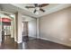 Bedroom featuring wood floors, ceiling fan, access to kitchen, and sliding mirrored closet at 56 E Serene Ave # 306, Las Vegas, NV 89123