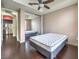 Bedroom with hardwood floors, a ceiling fan, and a closet with sliding mirror doors at 56 E Serene Ave # 306, Las Vegas, NV 89123