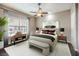 Comfortable bedroom with a ceiling fan, neutral walls, and a bright window with neighborhood view at 56 E Serene Ave # 306, Las Vegas, NV 89123