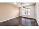 Bright bedroom featuring wood flooring, a ceiling fan, and a window with blinds for natural light at 56 E Serene Ave # 306, Las Vegas, NV 89123