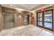 Hallway featuring tile floors, elevators, and exterior doors with community courtyard views at 56 E Serene Ave # 306, Las Vegas, NV 89123