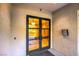 Elegant glass front door entrance to a building, with an intercom system on the outside wall at 56 E Serene Ave # 306, Las Vegas, NV 89123