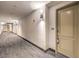 Long hallway with neutral carpet and freshly-painted walls at 56 E Serene Ave # 306, Las Vegas, NV 89123