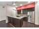 Modern kitchen with stainless steel appliances, dark cabinets, and granite countertops at 56 E Serene Ave # 306, Las Vegas, NV 89123