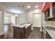 Modern kitchen with granite countertops, stainless steel appliances, and seamless flow to the living room at 56 E Serene Ave # 306, Las Vegas, NV 89123