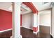 An open living space with wood floors, accent wall, pillars, and easy access to other rooms at 56 E Serene Ave # 306, Las Vegas, NV 89123