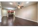 Open-concept living room featuring hardwood floors, a ceiling fan, and an adjacent kitchen area at 56 E Serene Ave # 306, Las Vegas, NV 89123