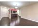 Open concept living area with dark wood floors and adjoining kitchen at 56 E Serene Ave # 306, Las Vegas, NV 89123