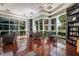 Sitting room featuring comfortable armchairs, bookshelves, and bright sunlight from large windows at 56 E Serene Ave # 306, Las Vegas, NV 89123
