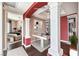 Staged office with built-in bookshelves and decorative columns, adjacent to a bedroom at 56 E Serene Ave # 306, Las Vegas, NV 89123