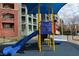 Playground featuring a colorful slide and apartment homes in the background at 56 E Serene Ave # 306, Las Vegas, NV 89123