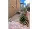 Backyard view featuring desert plants and gravel near brick-paved section at 566 Shewsbury Ave, Las Vegas, NV 89178