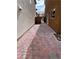 Brick-paved backyard featuring stucco walls and a view of the gate at 566 Shewsbury Ave, Las Vegas, NV 89178