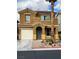 Charming two-story home with a well-maintained front yard, mature landscaping, and a convenient attached garage at 566 Shewsbury Ave, Las Vegas, NV 89178