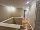Hallway with wood-look floors and neutral paint, leading to bedrooms or other living spaces at 566 Shewsbury Ave, Las Vegas, NV 89178